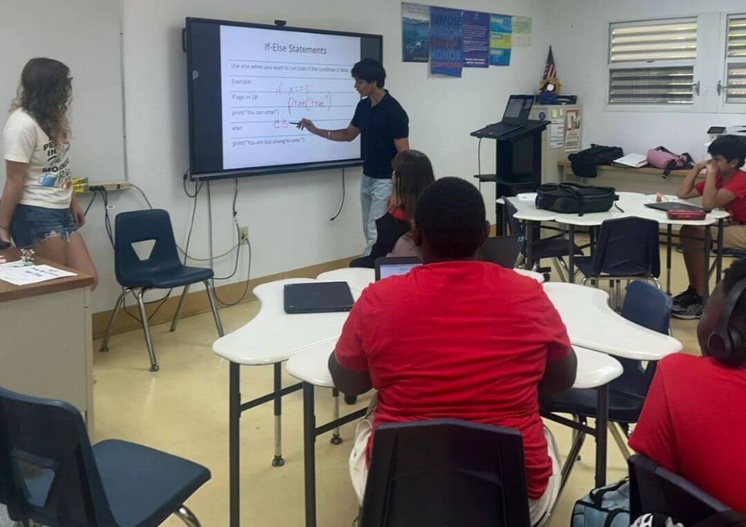 Arihant Jaggi presenting a coding lesson to students at a Miami high school