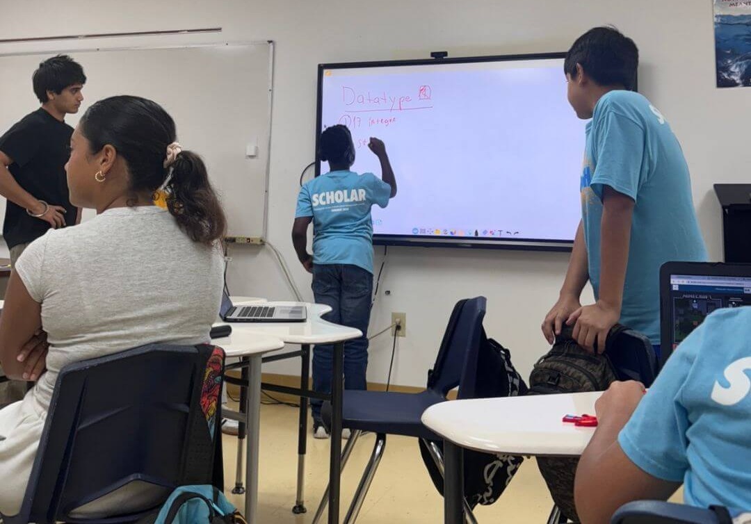 Arihant Jaggi presenting a coding lesson to students at a Miami high school